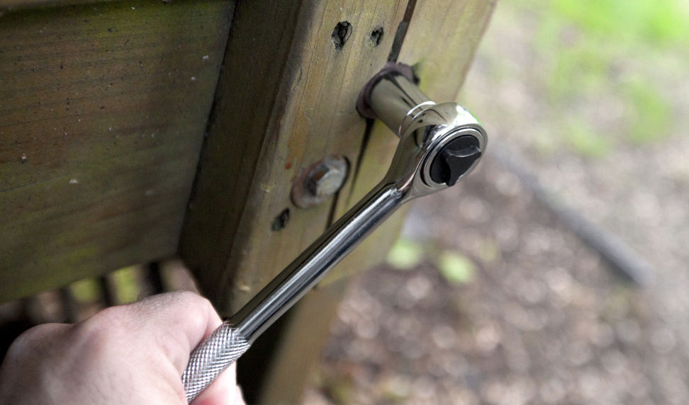 Tightening a lag bolt with a ratchet and socket